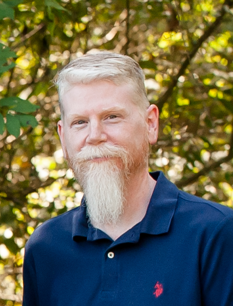 Steve — Founder of OpIntellect, smiling with signature gray goatee
